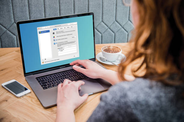 A girl working on a computer with a cup of coffee