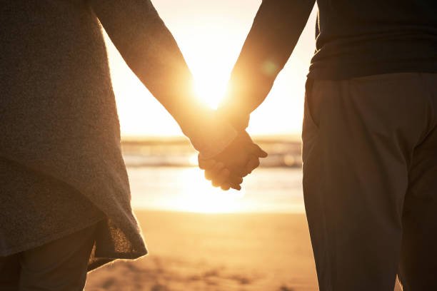 Couple holding each other's hand at a beach